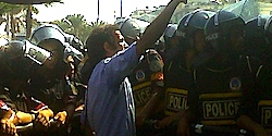 Man protesting in Tahrir Square the midst of special police