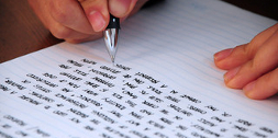 Person writing on notepaper 